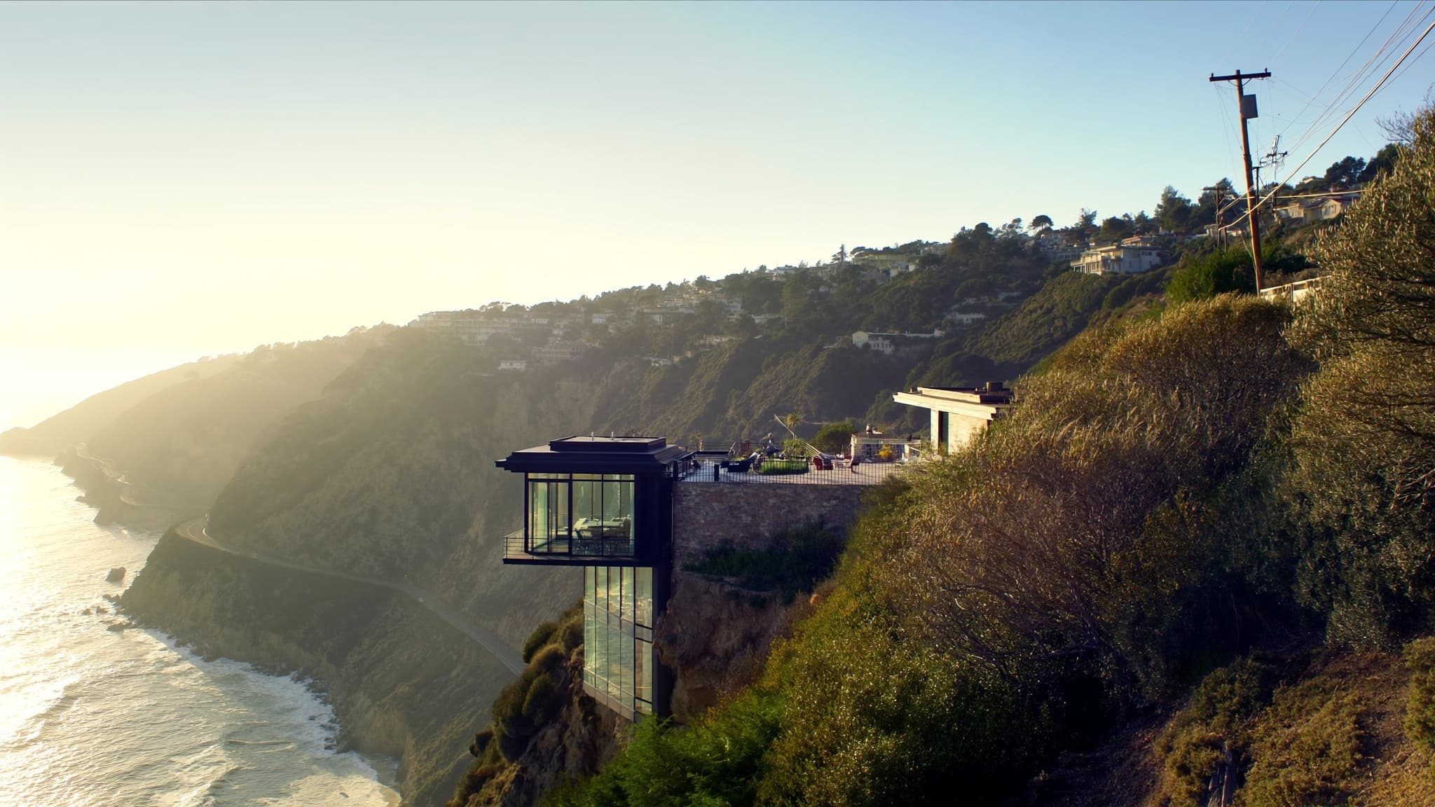 Modern cliffside home on the California coast at sunset